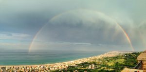 rainbow over a coastline