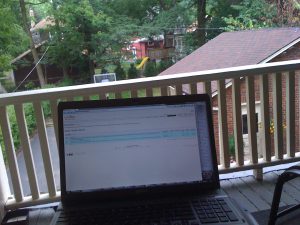 working on the balcony with laptop